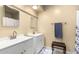 Clean bathroom with double vanity, updated fixtures, and a shower/tub combo at 6317 E Pinchot Ave, Scottsdale, AZ 85251