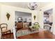 Bright dining room features a wooden table, chairs, and view into living room at 6317 E Pinchot Ave, Scottsdale, AZ 85251