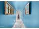 Hallway with blue walls, tile flooring, and artwork at 6317 E Pinchot Ave, Scottsdale, AZ 85251