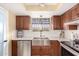 Updated kitchen featuring stainless steel appliances and wooden cabinetry at 6317 E Pinchot Ave, Scottsdale, AZ 85251