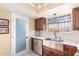 Modern kitchen with stainless steel sink, updated cabinetry, and farmhouse style at 6317 E Pinchot Ave, Scottsdale, AZ 85251