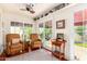 Bright sunroom with two armchairs and access to backyard at 6317 E Pinchot Ave, Scottsdale, AZ 85251