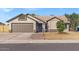 Tan house with brown garage door and brick pathway leading to entrance at 670 W Barrow Dr, Chandler, AZ 85225