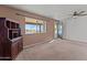 Bright living room with carpet, ceiling fan, and view at 735 W Hermosa Dr, Wickenburg, AZ 85390