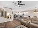 Living room with open kitchen, island, and hardwood floors at 8231 W Encinas Ln, Phoenix, AZ 85043