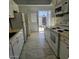 Kitchen boasts white cabinets, tile floors and backyard access at 849 N Revere St # B, Mesa, AZ 85201
