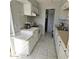 Kitchen with white cabinets, tile floors, and appliances at 849 N Revere St # B, Mesa, AZ 85201