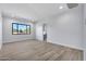 Light-filled bedroom with wood-look tile flooring and large window at 8714 E Tether Trl, Scottsdale, AZ 85255