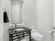 Simple, clean powder room with dark vanity and a modern toilet at 8745 N 73Rd Way, Scottsdale, AZ 85258