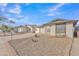 Cute single-story home with a gravel front yard and a two-car garage at 8760 W Meadow Dr, Peoria, AZ 85382