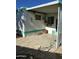 Covered patio area adjacent to the mobile home at 9623 E Baywood Ave, Mesa, AZ 85208