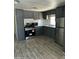 Updated kitchen with gray cabinets, stainless appliances, and wood-look flooring at 9623 E Baywood Ave, Mesa, AZ 85208