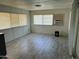 Bright living room with wood-look flooring and window blinds at 9623 E Baywood Ave, Mesa, AZ 85208