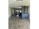 Open living space with wood-look flooring and kitchen view at 9623 E Baywood Ave, Mesa, AZ 85208