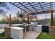 Modern outdoor kitchen with grill, pizza oven, and pergola at 10040 E Happy Valley Rd # 446, Scottsdale, AZ 85255