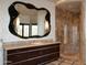 Elegant bathroom with large mirror, double vanity, and walk-in shower at 11271 E Cinder Cone Trl, Scottsdale, AZ 85262