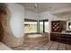 Bathroom with soaking tub, stone shower, and desert views at 11271 E Cinder Cone Trl, Scottsdale, AZ 85262