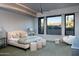 Spacious bedroom with large windows, plush bedding, and sitting area at 11271 E Cinder Cone Trl, Scottsdale, AZ 85262