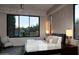 Comfortable bedroom with large windows, neutral decor, and cozy sitting chair at 11271 E Cinder Cone Trl, Scottsdale, AZ 85262
