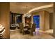 Elegant dining room features a wine cellar and modern chandelier at 11271 E Cinder Cone Trl, Scottsdale, AZ 85262