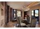 Sophisticated dining area with a glass top table and modern chandelier at 11271 E Cinder Cone Trl, Scottsdale, AZ 85262