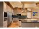 Modern kitchen features stainless steel appliances and granite countertops at 11271 E Cinder Cone Trl, Scottsdale, AZ 85262