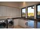 Bright laundry room with modern appliances and ample cabinetry at 11271 E Cinder Cone Trl, Scottsdale, AZ 85262