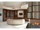 Living area with curved seating and a modern fireplace at 11271 E Cinder Cone Trl, Scottsdale, AZ 85262