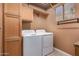 Laundry room with washer, dryer, cabinets, and countertop at 1231 W Hawken Way, Chandler, AZ 85286