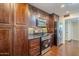 Modern kitchen with dark wood cabinets and granite countertops at 12436 N 105Th Ave, Sun City, AZ 85351