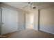 Bedroom with double doors leading to a full bathroom at 15313 W Lundberg St, Surprise, AZ 85374