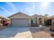 Single-story house with a two-car garage and desert landscaping at 15313 W Lundberg St, Surprise, AZ 85374