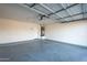 Attached garage with open overhead door, water heater and access to home at 15313 W Lundberg St, Surprise, AZ 85374