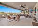 Large covered patio with multiple seating areas and golf course view at 17620 N Stone Haven Dr, Surprise, AZ 85374