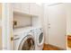 Bright laundry room, washer, dryer, and built-in cabinets at 17808 N Navarro Ct, Surprise, AZ 85374