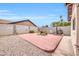 Charming backyard with brick patio, gravel landscaping, and mature plants at 2110 W Silvergate Dr, Chandler, AZ 85224