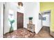 Inviting entryway with terracotta tile flooring and wood cabinet at 2110 W Silvergate Dr, Chandler, AZ 85224