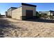 Detached garage with brown door and stucco exterior at 24201 N 181St Dr, Surprise, AZ 85387