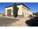 Detached garage with brown door and stucco exterior at 24201 N 181St Dr, Surprise, AZ 85387