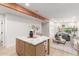 Modern kitchen with light wood cabinets, marble island, and stainless steel appliances at 3753 E Paradise Dr, Phoenix, AZ 85028