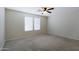 Bright bedroom with neutral carpeting and ceiling fan at 4047 E Rowel Rd, Phoenix, AZ 85050