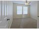 Well-lit bedroom featuring carpet and window blinds at 4047 E Rowel Rd, Phoenix, AZ 85050