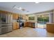 Kitchen with stainless steel appliances, wood cabinets, and pool view at 4047 E Rowel Rd, Phoenix, AZ 85050