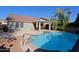 Inviting backyard oasis with sparkling pool, covered patio, and mature landscaping at 4047 E Rowel Rd, Phoenix, AZ 85050