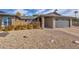 House exterior with modern gray accents, drought-tolerant landscaping, and a paved driveway at 4620 W Dahlia Dr, Glendale, AZ 85304