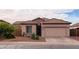 One-story house with a two-car garage and desert landscaping at 5010 S Veneto --, Mesa, AZ 85212