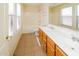 Bathroom with double sinks, tiled floor, and bathtub at 533 W Prickly Pear Dr, Casa Grande, AZ 85122