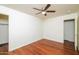 Well-lit bedroom featuring wood floors and a ceiling fan at 533 W Prickly Pear Dr, Casa Grande, AZ 85122