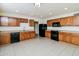 Kitchen features wood cabinets, black appliances, and tile floors at 533 W Prickly Pear Dr, Casa Grande, AZ 85122