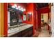 Double vanity bathroom with dark wood cabinets and red walls at 5640 E Miramonte Dr, Cave Creek, AZ 85331